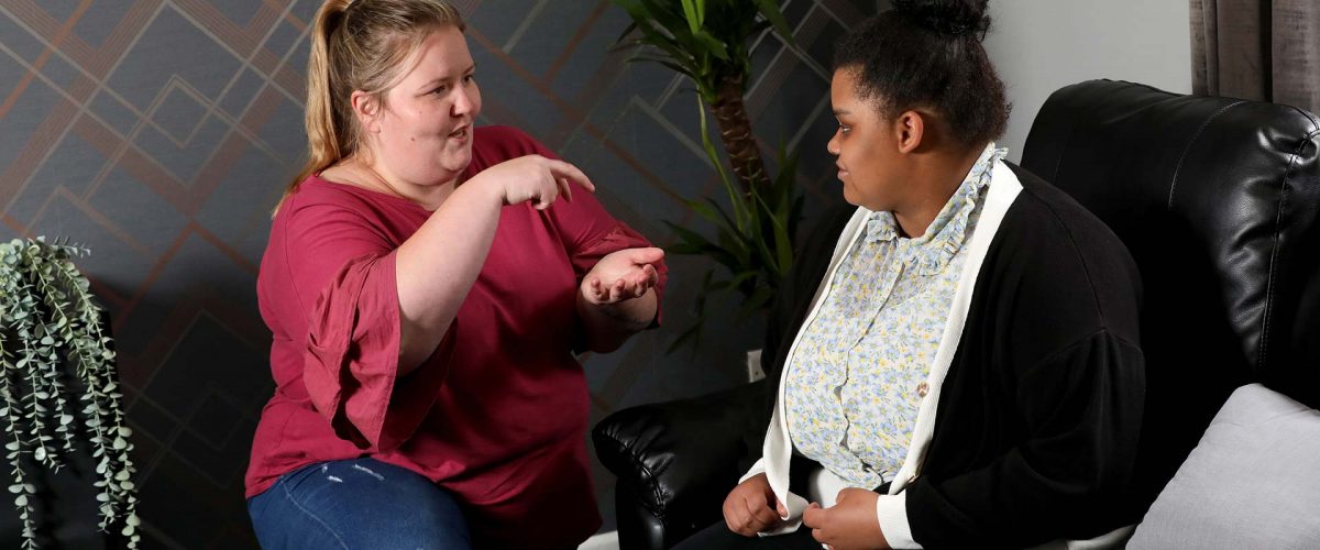 A woman talking with her carer