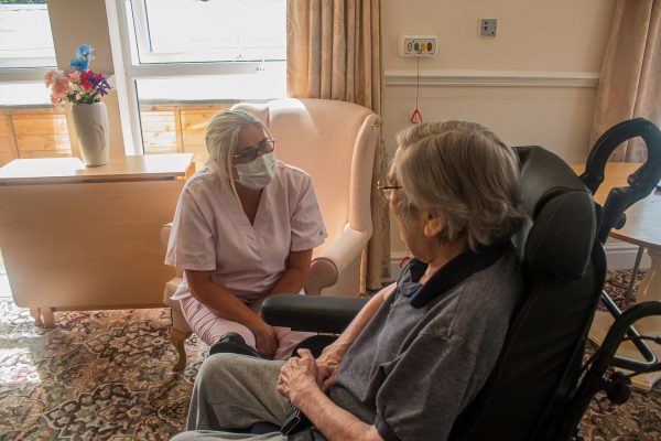A carer talking with a care home resident.